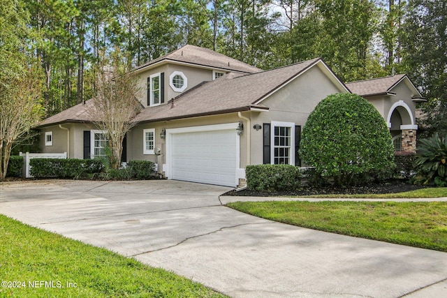 front facade with a front lawn and a garage