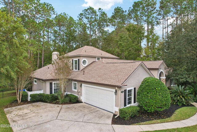 2693 Seneca Dr, Saint Johns, FL 32259 - traditional home with stucco siding, fence, an attached garage, and roof with shingles
