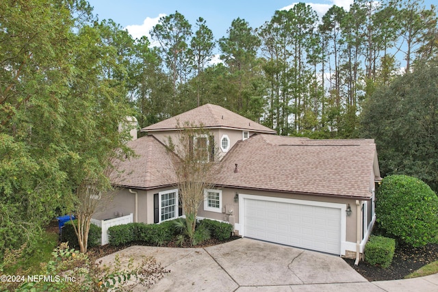 2693 Seneca Dr, Saint Johns, FL 32259 - traditional home featuring stucco siding, concrete driveway, roof with shingles, and a garage