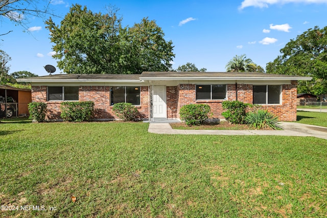 ranch-style home with a front lawn