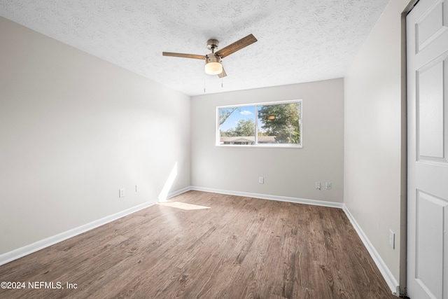 unfurnished room with ceiling fan, a textured ceiling, and hardwood / wood-style floors