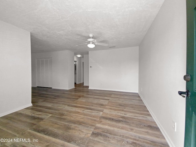 unfurnished living room with ceiling fan, wood-type flooring, and a textured ceiling