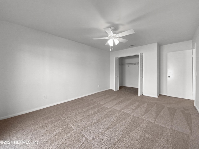 unfurnished bedroom with a closet, ceiling fan, and dark colored carpet