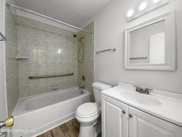 full bathroom featuring vanity, tiled shower / bath combo, toilet, and hardwood / wood-style floors