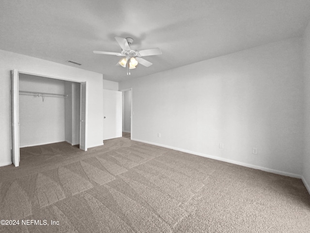 unfurnished bedroom with carpet, a closet, baseboards, and ceiling fan