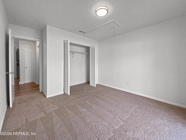 unfurnished bedroom featuring carpet floors and a closet