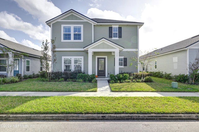 view of front facade with a front lawn and board and batten siding