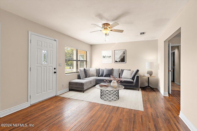 living room featuring wood-type flooring and ceiling fan