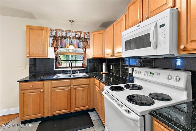 kitchen featuring white appliances, tasteful backsplash, sink, light tile patterned flooring, and decorative light fixtures