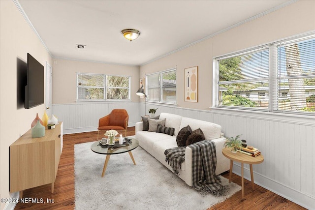 living room with hardwood / wood-style flooring and ornamental molding