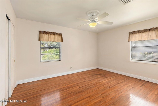 empty room with hardwood / wood-style flooring and ceiling fan