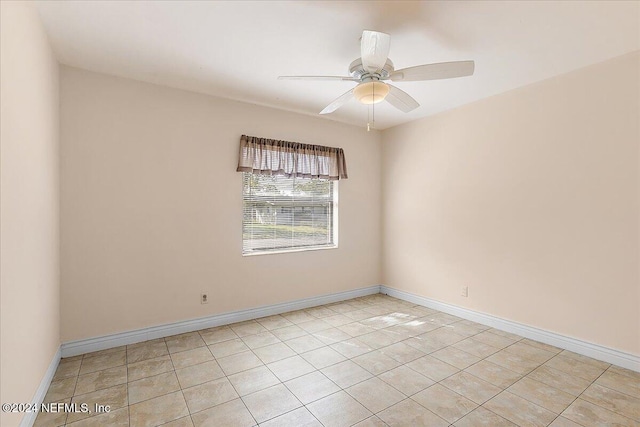 tiled empty room featuring ceiling fan