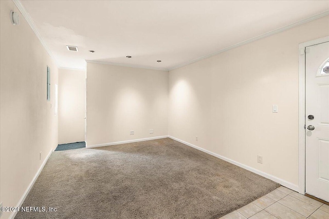 carpeted empty room featuring crown molding