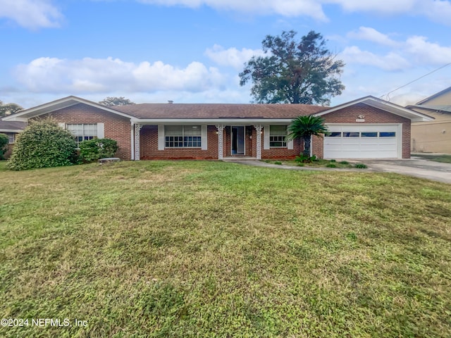 ranch-style home featuring a garage and a front lawn