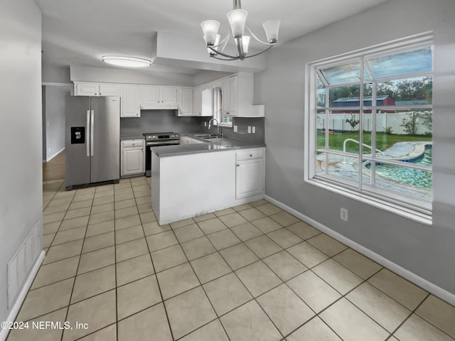 kitchen with sink, stainless steel appliances, decorative light fixtures, white cabinets, and light tile patterned floors