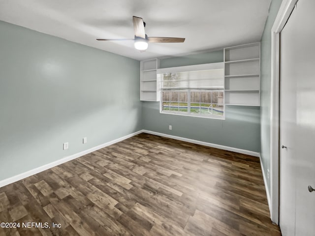 unfurnished bedroom featuring dark wood-type flooring and ceiling fan