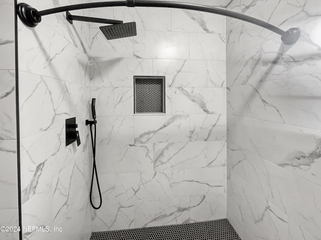 bathroom with tiled shower