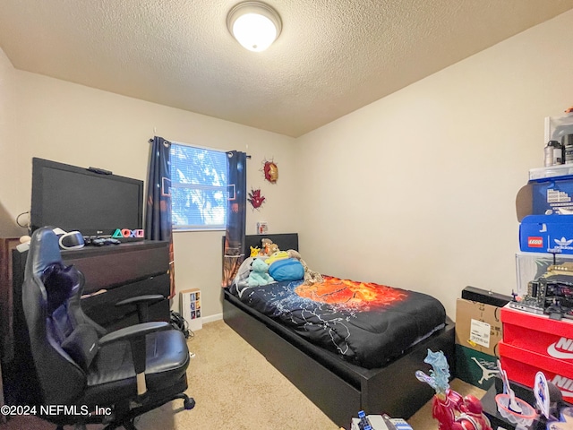 bedroom featuring carpet and a textured ceiling