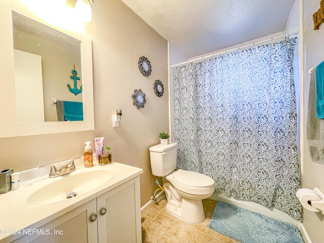 bathroom with a textured ceiling, vanity, tile patterned floors, and toilet