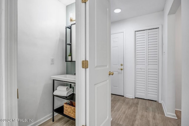 corridor with light wood-type flooring