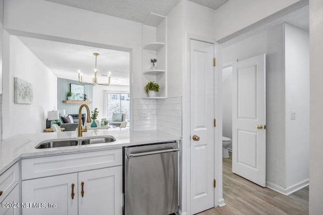 kitchen featuring sink, a textured ceiling, stainless steel dishwasher, light hardwood / wood-style flooring, and white cabinets