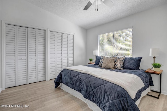 bedroom featuring ceiling fan, a textured ceiling, light hardwood / wood-style flooring, and vaulted ceiling