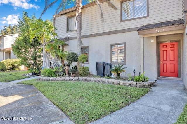 8300 Plaza Gate Ln Unit 1183, Jacksonville, FL 32217 - view of front of home with stucco siding and a front yard