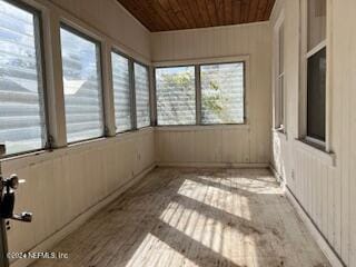 unfurnished sunroom featuring wood ceiling