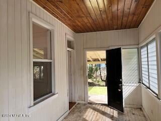 entryway featuring wood walls and wooden ceiling