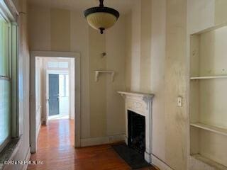 unfurnished living room featuring hardwood / wood-style floors