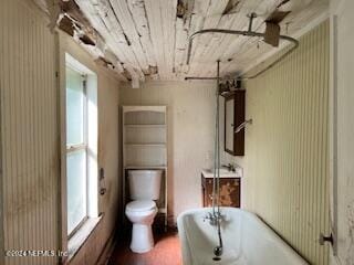 bathroom with a bathtub, toilet, and wooden ceiling