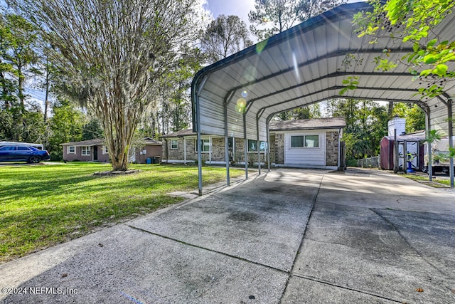 view of vehicle parking featuring a lawn and a carport