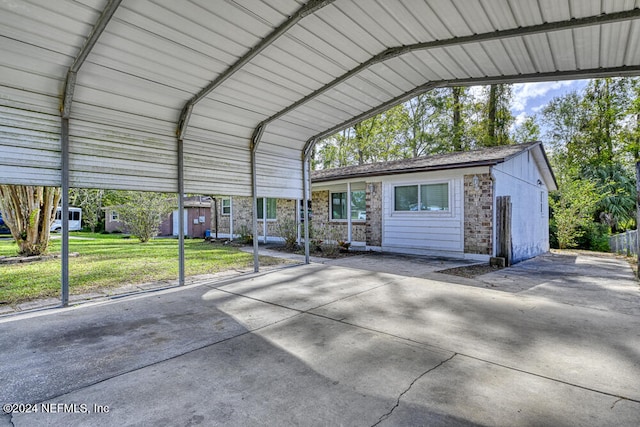 view of parking featuring a lawn and a carport