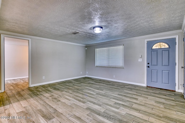 entryway featuring crown molding, a textured ceiling, and light hardwood / wood-style floors