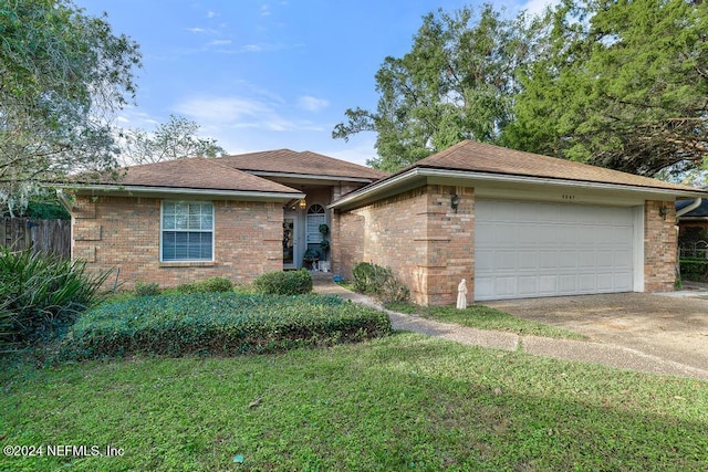 ranch-style home with a front lawn and a garage