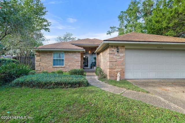 view of front facade with a garage and a front lawn