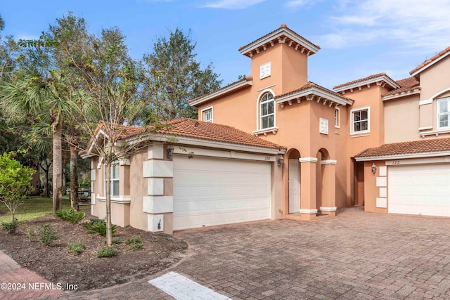 mediterranean / spanish home featuring a garage