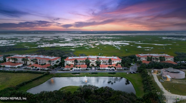 aerial view at dusk with a water view