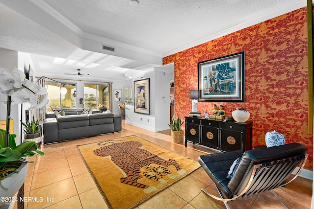 living room featuring ornamental molding, a textured ceiling, ceiling fan, and tile patterned flooring