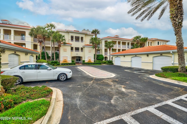 view of front of property with a garage and a balcony