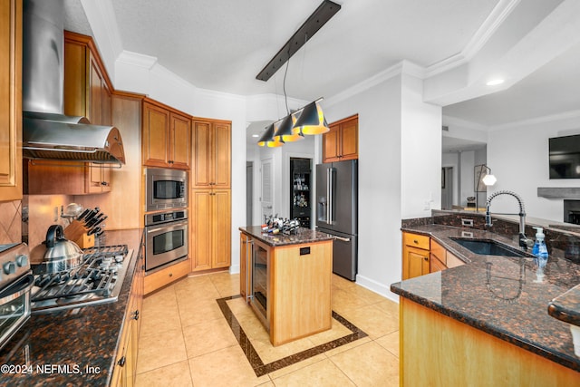 kitchen featuring ornamental molding, a kitchen island, wall chimney range hood, and stainless steel appliances