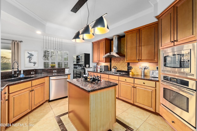 kitchen with wall chimney range hood, a kitchen island, light tile patterned flooring, pendant lighting, and stainless steel appliances