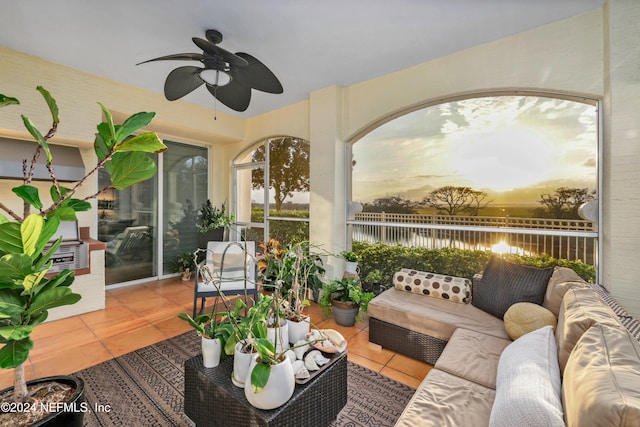 patio terrace at dusk with an outdoor living space and ceiling fan