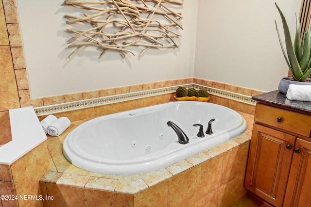 bathroom with vanity and a relaxing tiled tub