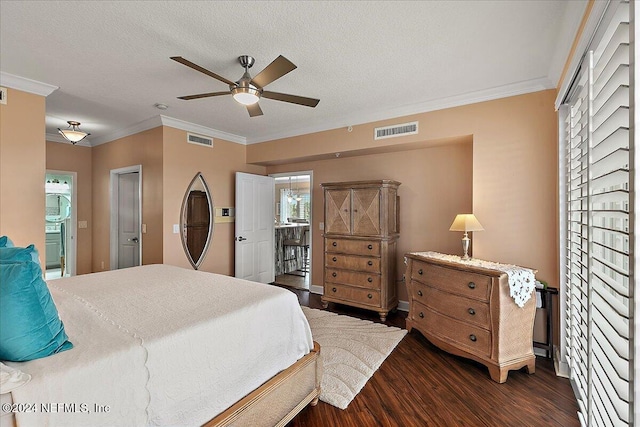 bedroom with ensuite bath, a textured ceiling, ceiling fan, ornamental molding, and dark hardwood / wood-style floors