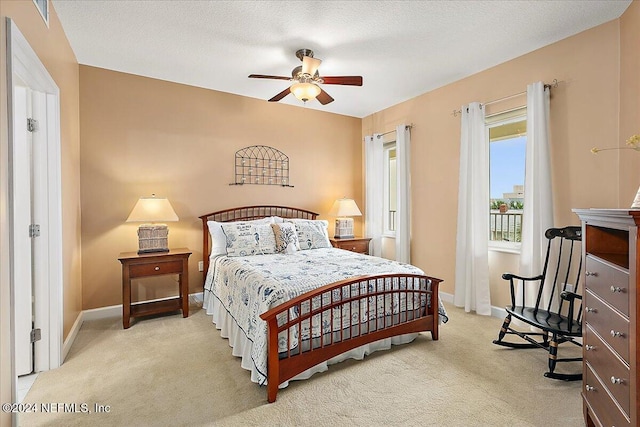 carpeted bedroom with a textured ceiling and ceiling fan