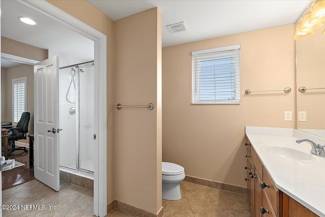 bathroom featuring vanity, tile patterned floors, toilet, and an enclosed shower