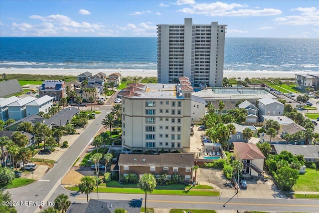 bird's eye view with a water view and a beach view