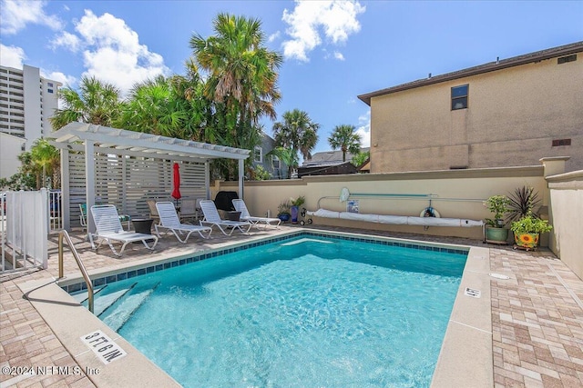 view of swimming pool with a pergola and a patio