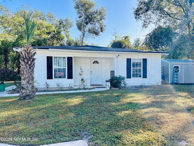 ranch-style house with a front yard and a storage unit